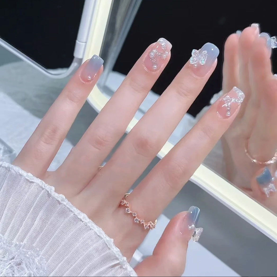 1Artistic nail decoration with glitter and butterfly details Miroken