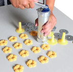 Cookie press made of stainless steel with attachments for creative cookies and pastries
